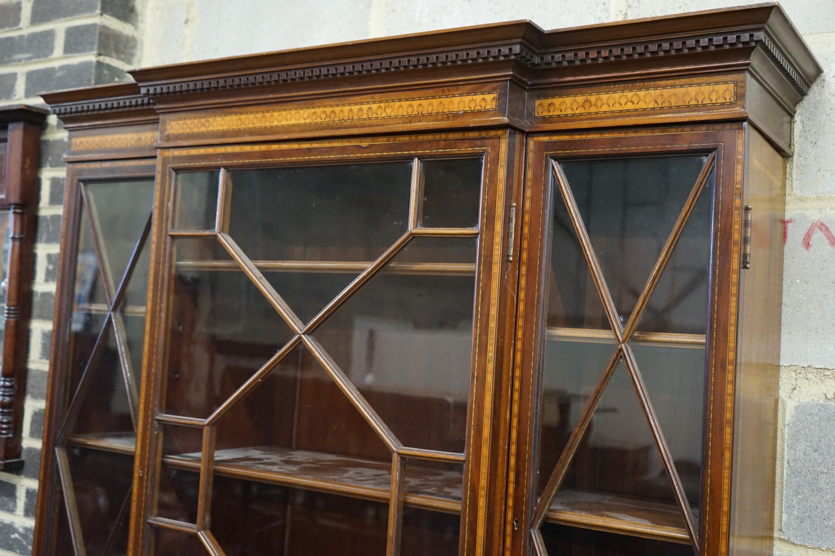A small Edwardian satinwood banded mahogany breakfront bookcase, length 120cm, depth 55cm, height 201cm